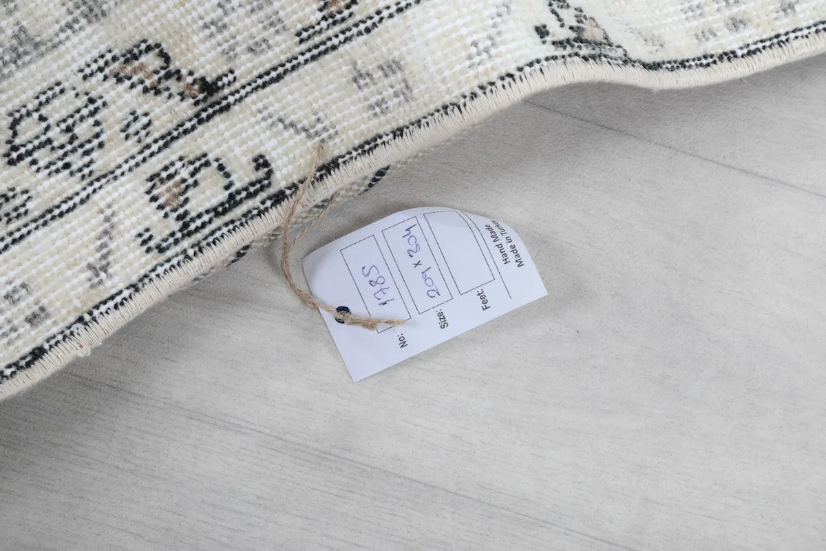 Tag attached to the rug, showing its dimensions and other product information