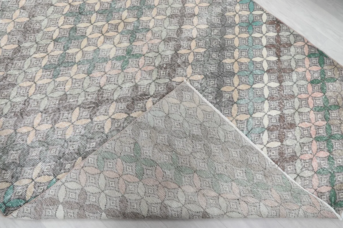 Corner of the rug folded back to reveal the cotton foundation and hand-knotted construction