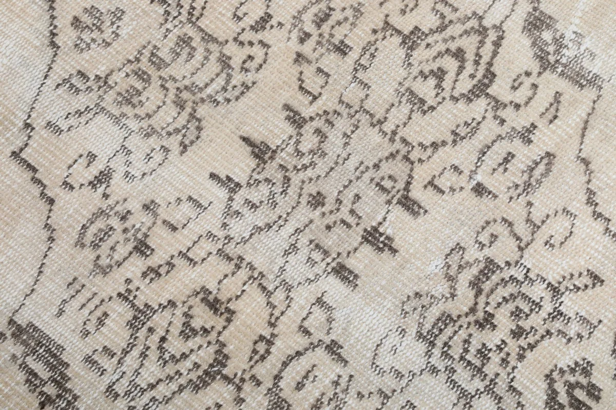 Detailed view of the intricate hand-knotted charcoal patterns and low pile texture