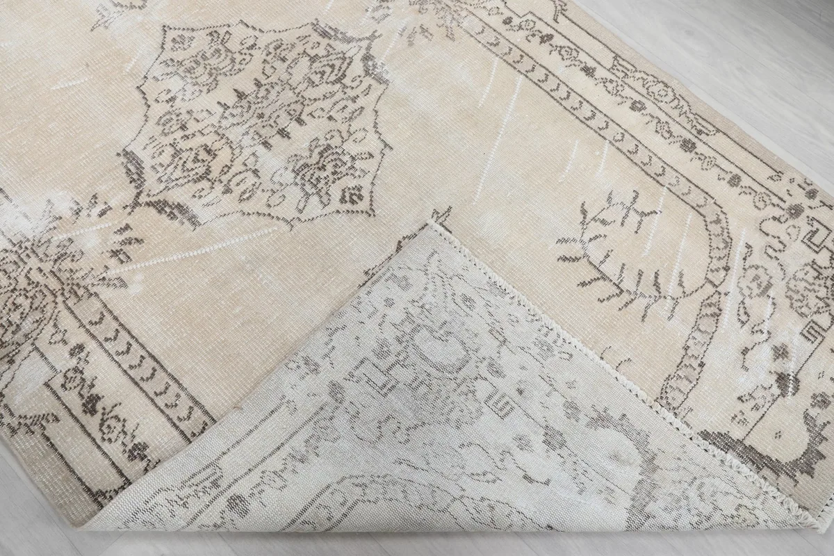 View of the back of the hand-knotted wool rug, showing the cotton foundation