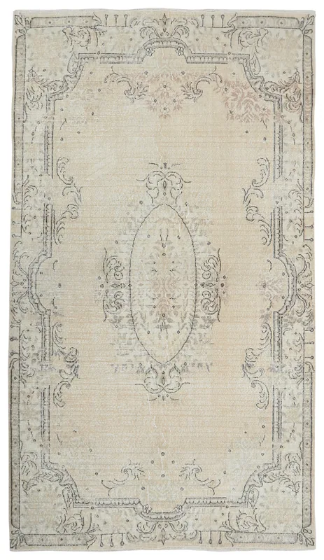 Full overhead view of the vintage Anatolian area rug with a cream field and charcoal medallion