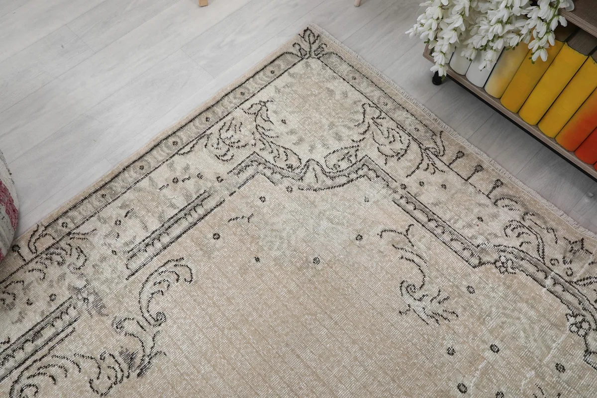 Corner detail of the rug, showing the intricate scrollwork and border patterns