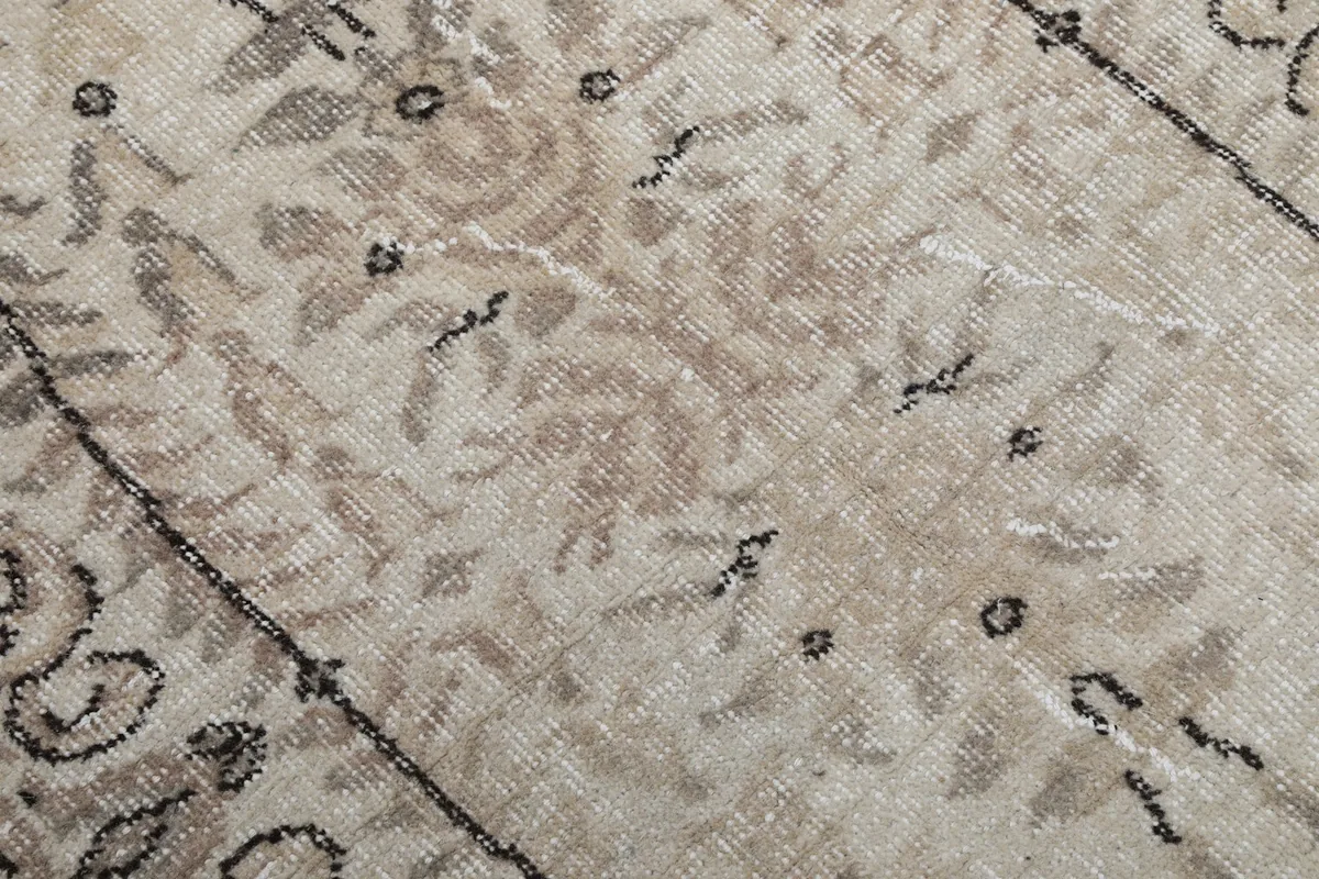 Texture detail of the hand-knotted wool pile, showing areas of wear and patina