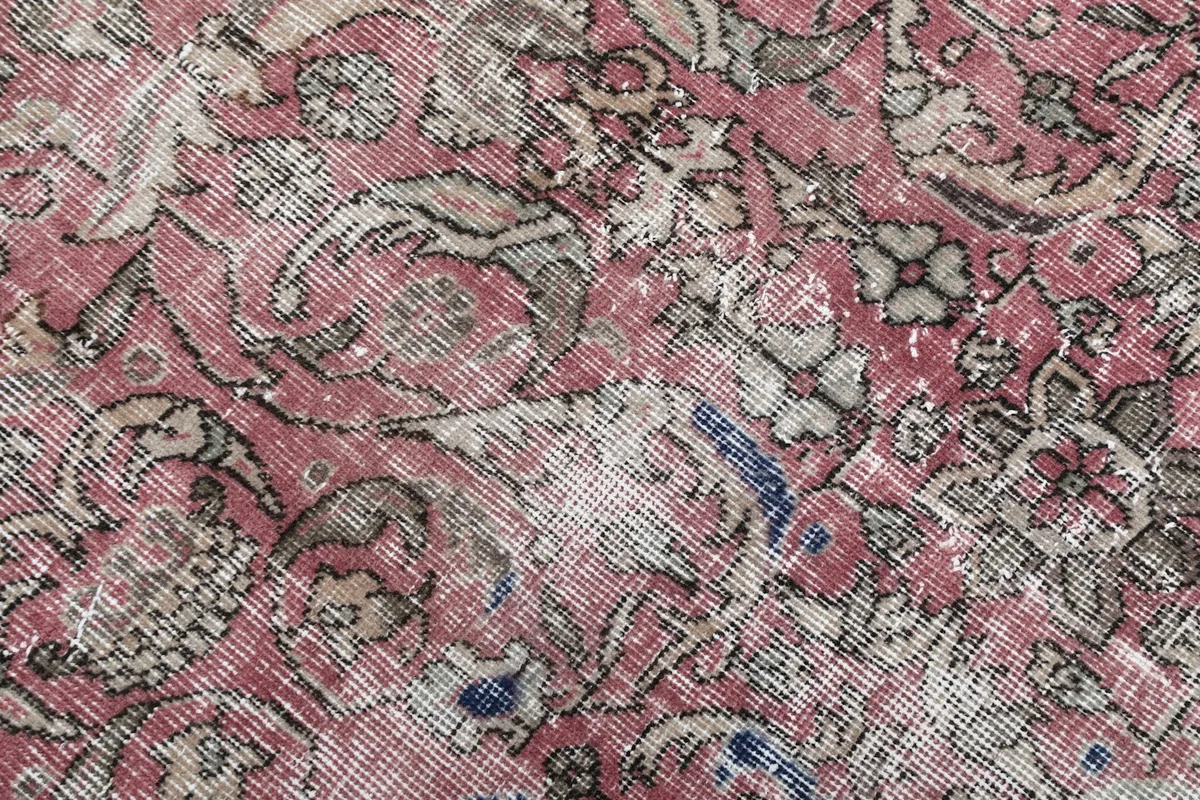 Detailed view of the intricate floral patterns and color variations in the rug's pile