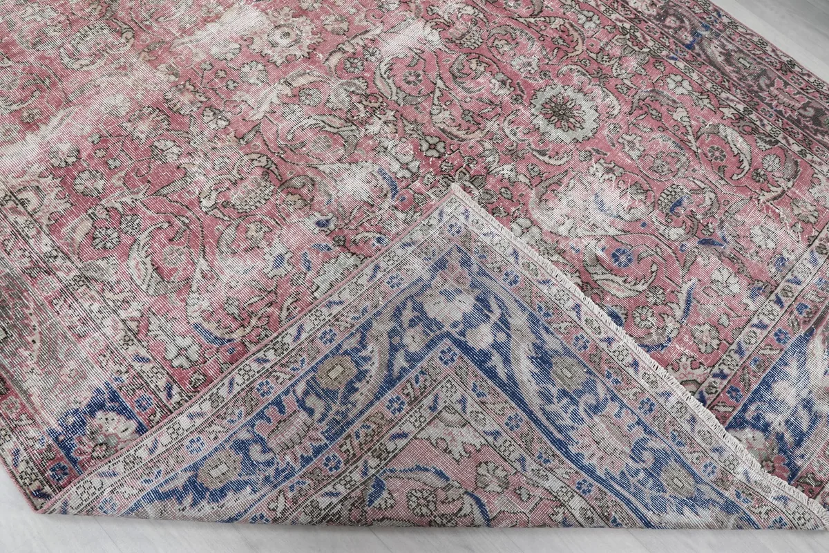 Folded corner of the rug revealing the back of the hand-knotted cotton foundation