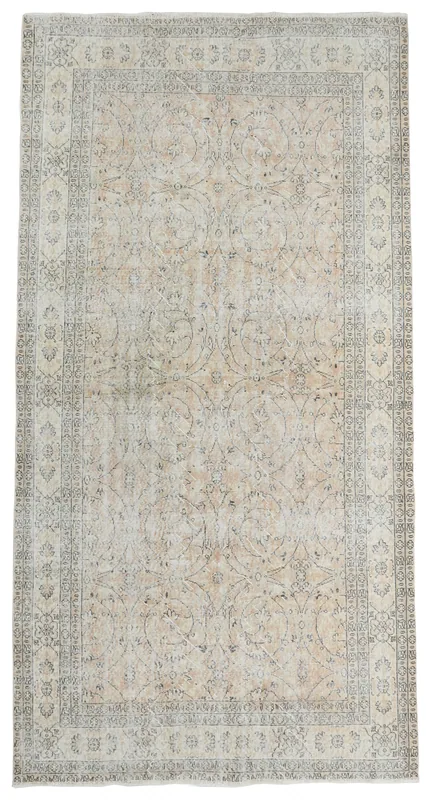 Full overhead view of the beige and rose floral vintage Anatolian area rug