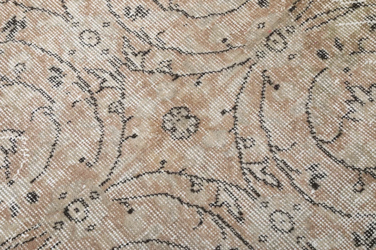 Close-up of the low pile and subtle rose and beige color variation with gray motifs
