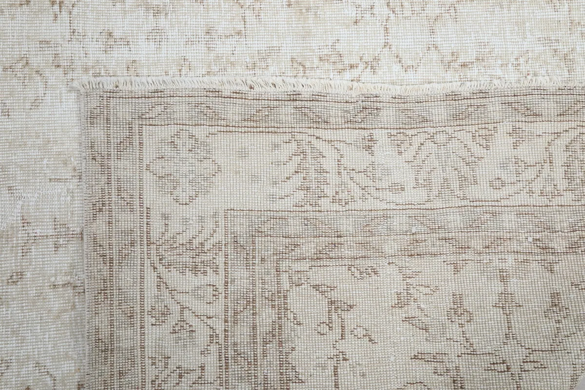 Close-up of a rug corner and border, highlighting the vintage craftsmanship.