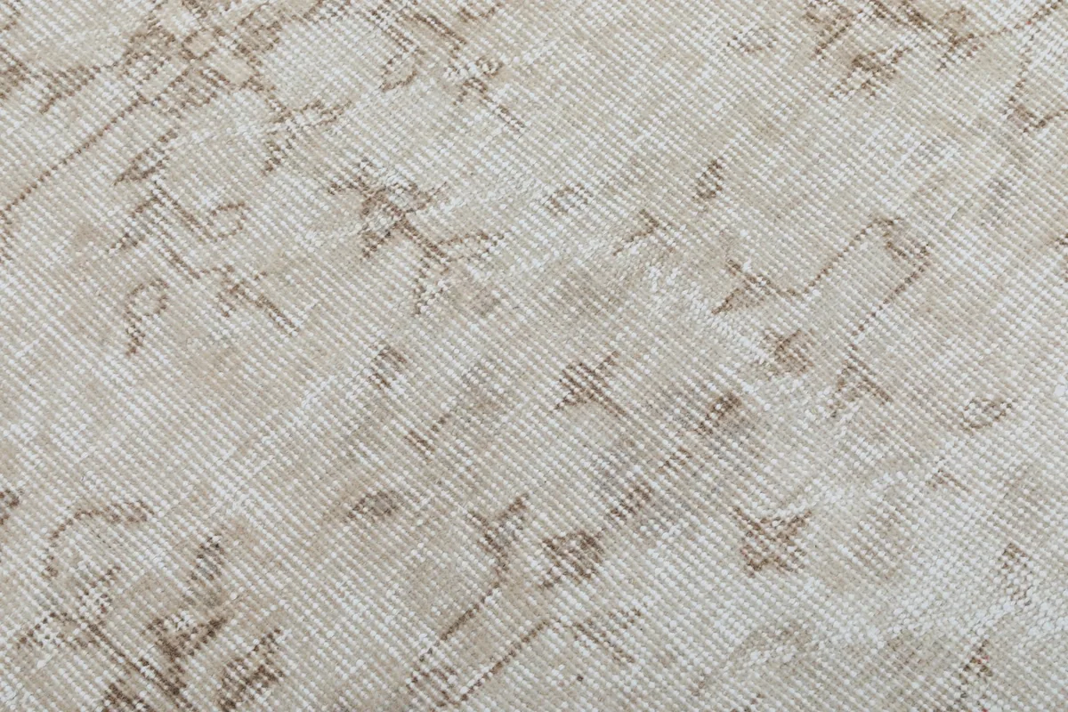 Close-up of the low wool pile, showcasing the hand-knotted texture and wear.
