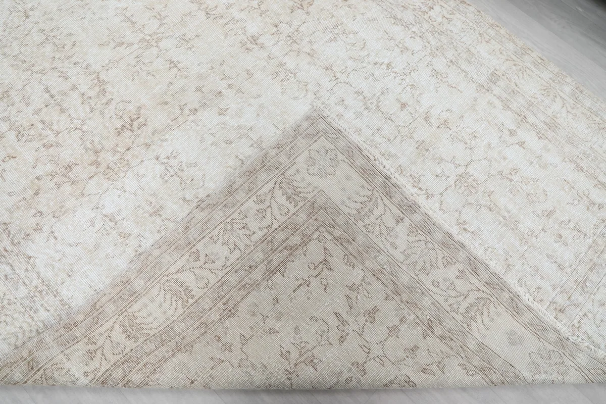 View of the rug's reverse side, showing the cotton foundation and knotting.