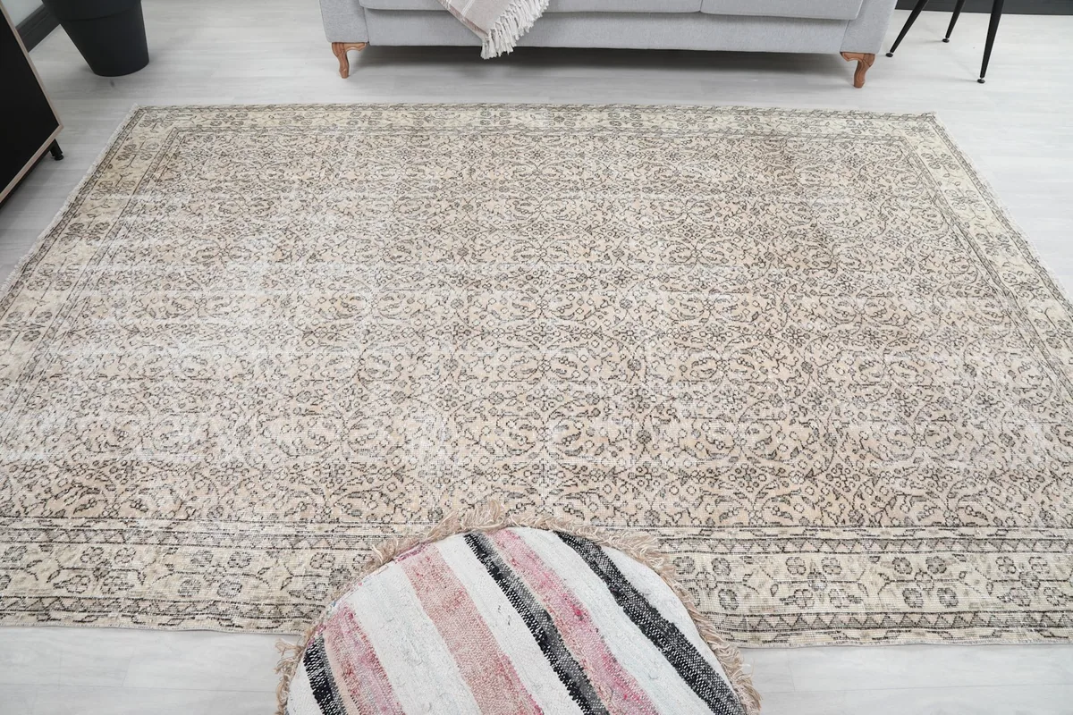 Room view capturing the full length of the rug with an ottoman in the foreground
