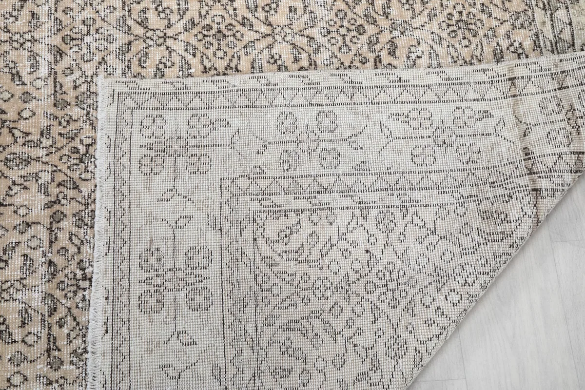 Close-up of the rug's reverse side, showing the knotting and foundation structure