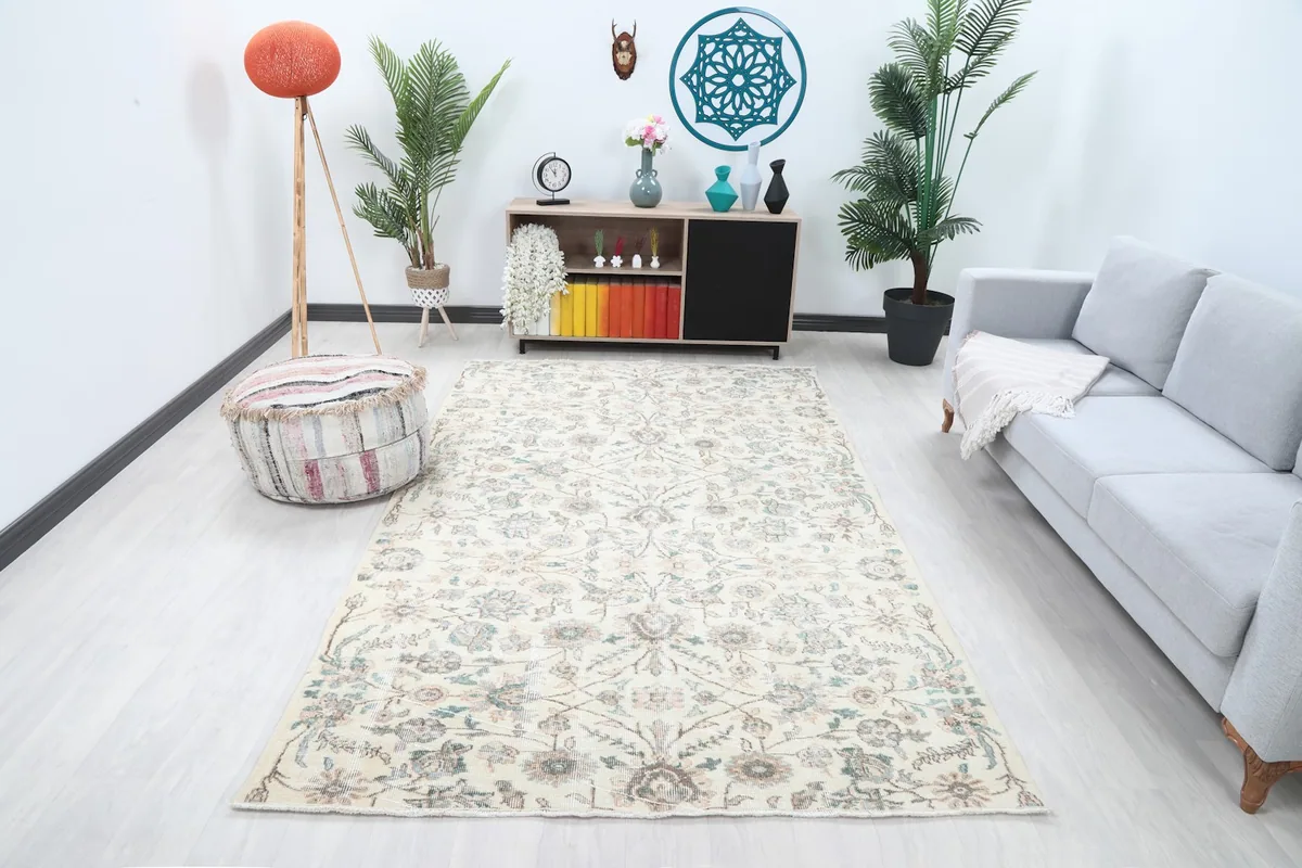 Ivory vintage rug in a living room setting with a light gray sofa and modern decor