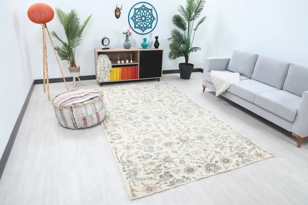 Angle view of the ivory botanical rug in a contemporary living space with plants and seating