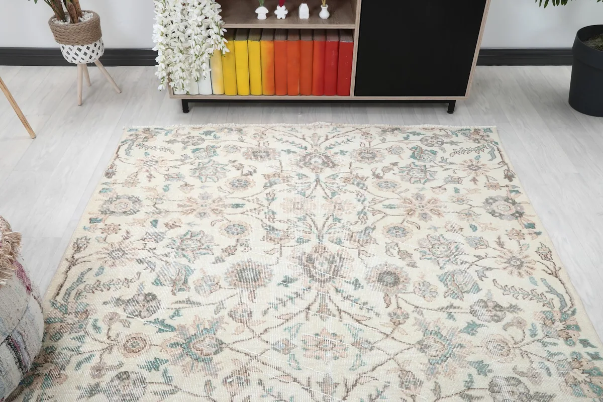 Overhead view of the ivory botanical lattice rug displaying its full design in a room