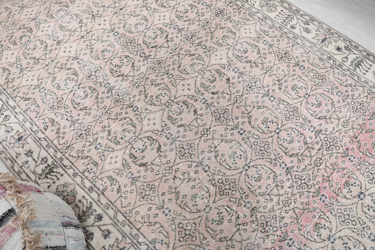 Overhead detail of the rug's field, highlighting the subtle color variations and motifs