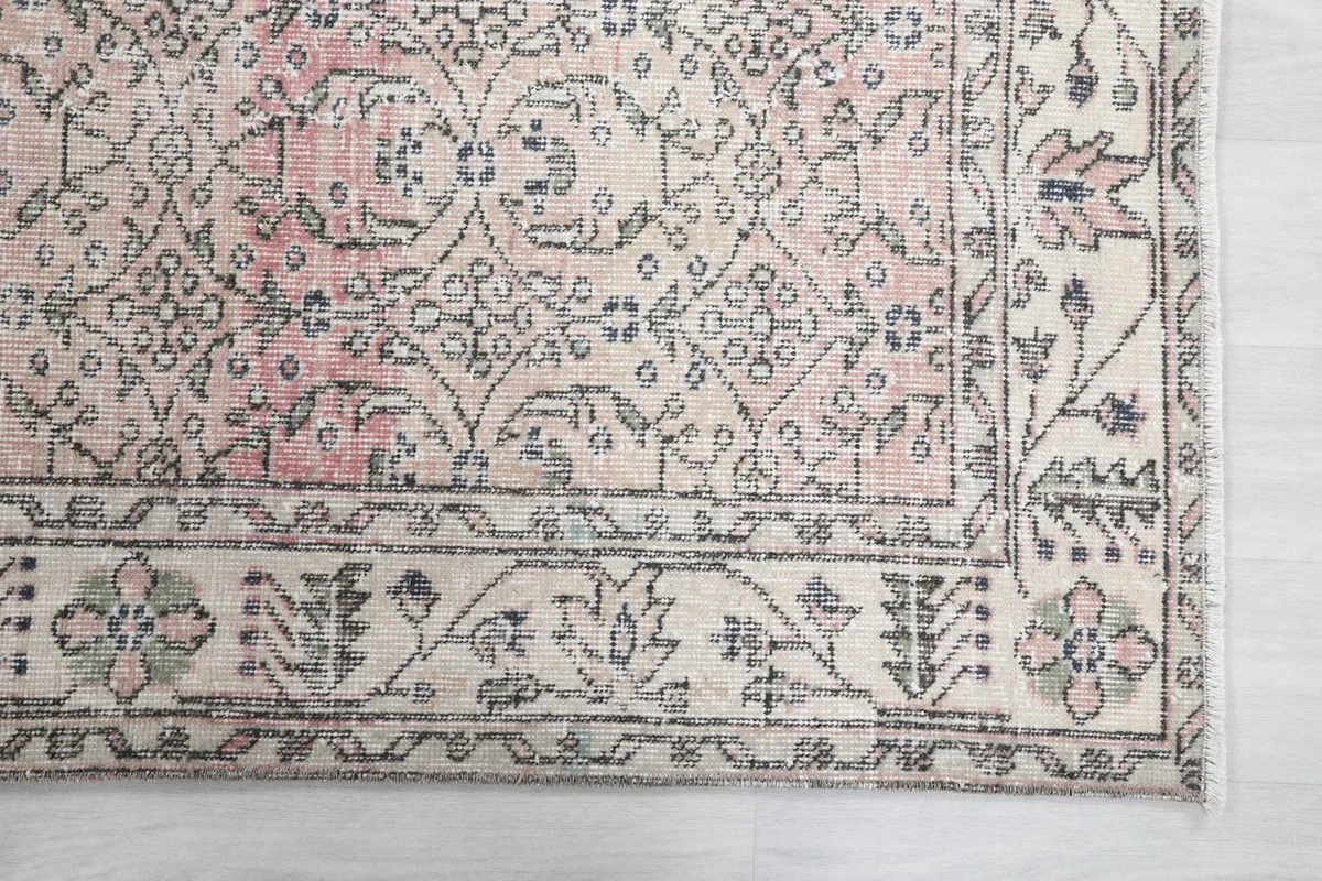 Detail of the ivory border with intricate floral and geometric patterns