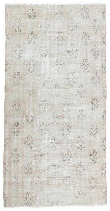 Full overhead view of the 5x9 ivory vintage Anatolian rug with floral motifs