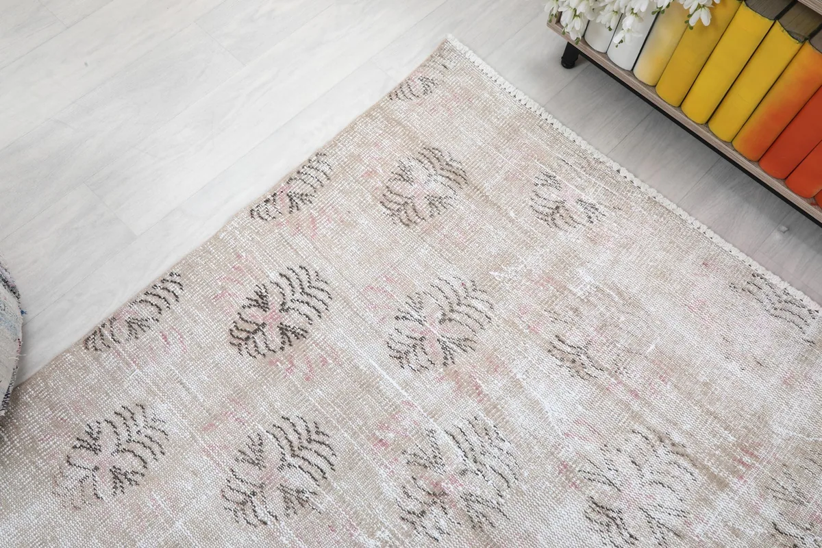 Corner view of the rug, illustrating the floral-geometric patterns and overall texture