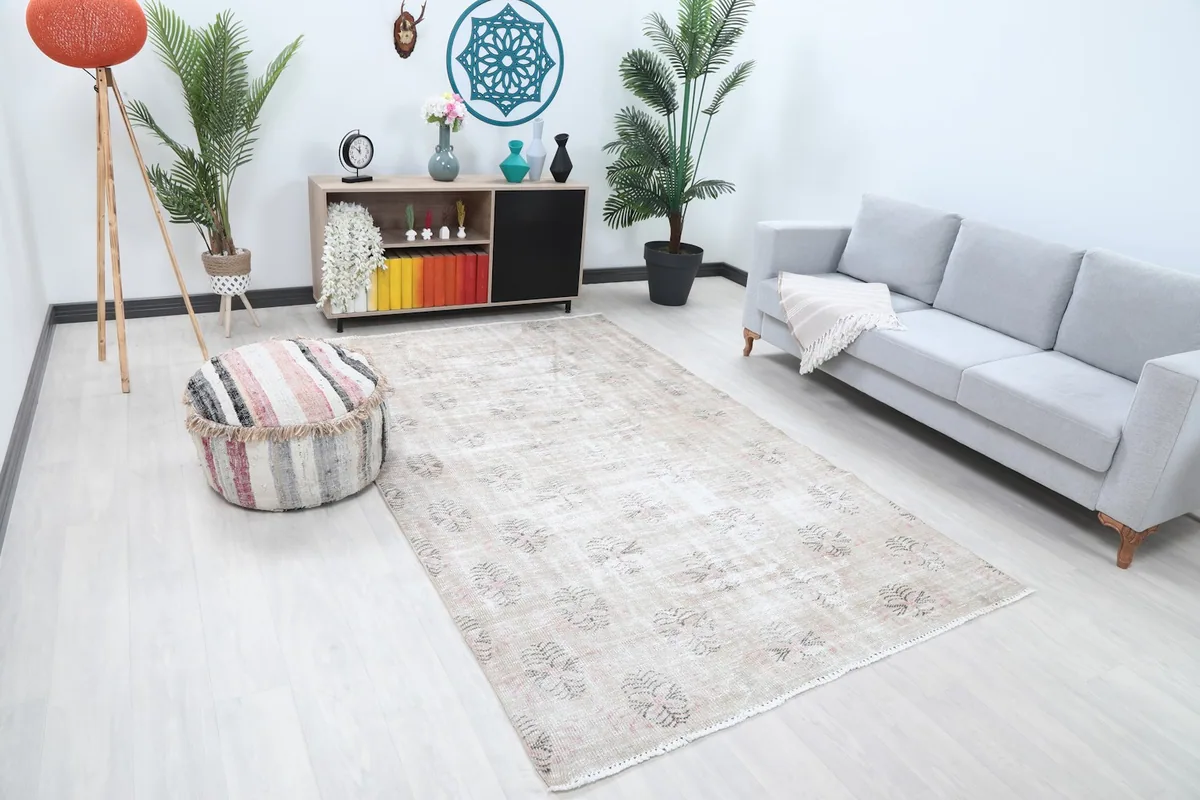 Wide view of the ivory rug in a spacious room, showing its scale relative to furniture