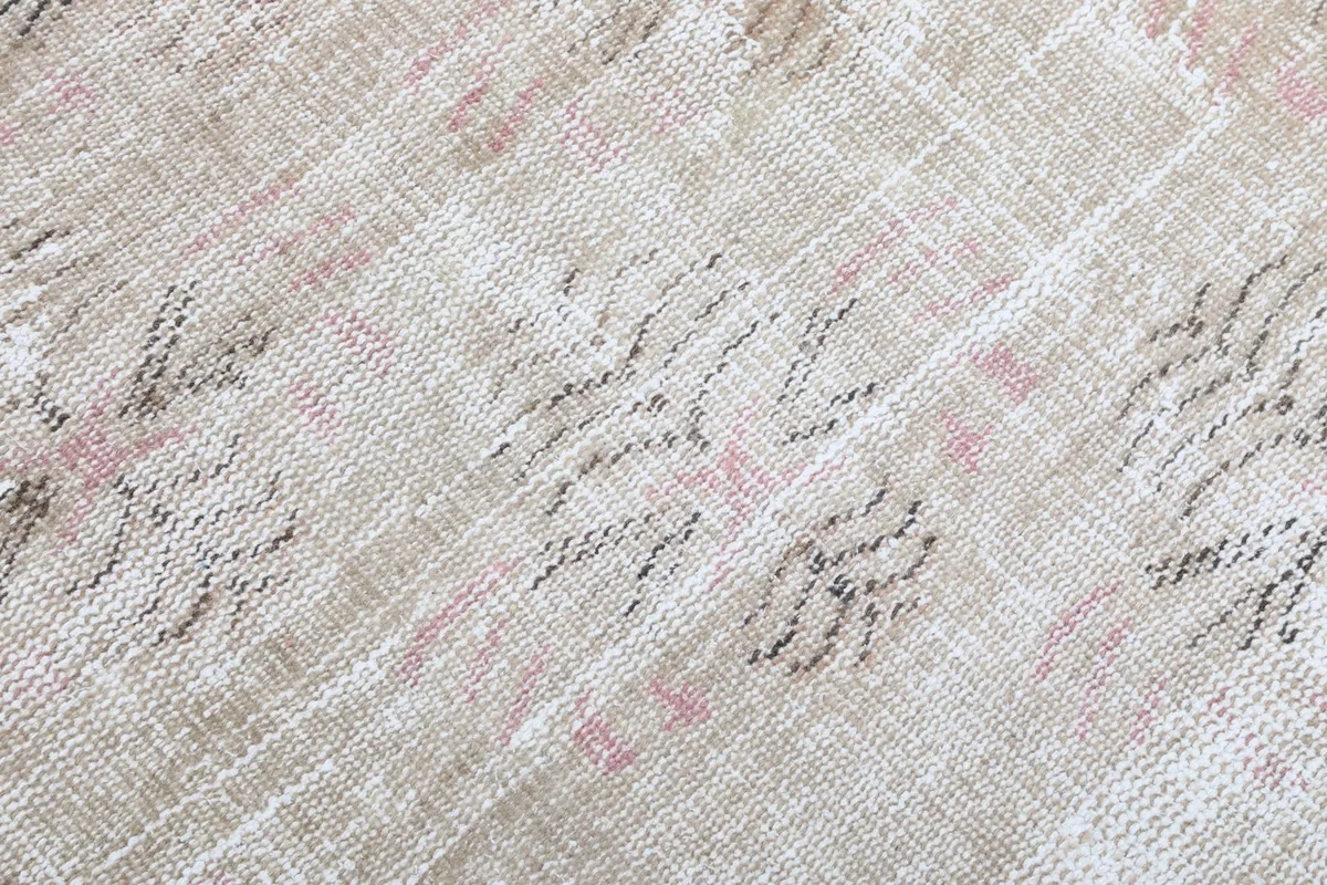 Detailed close-up showing the low pile, weave, and individual knots of the rug