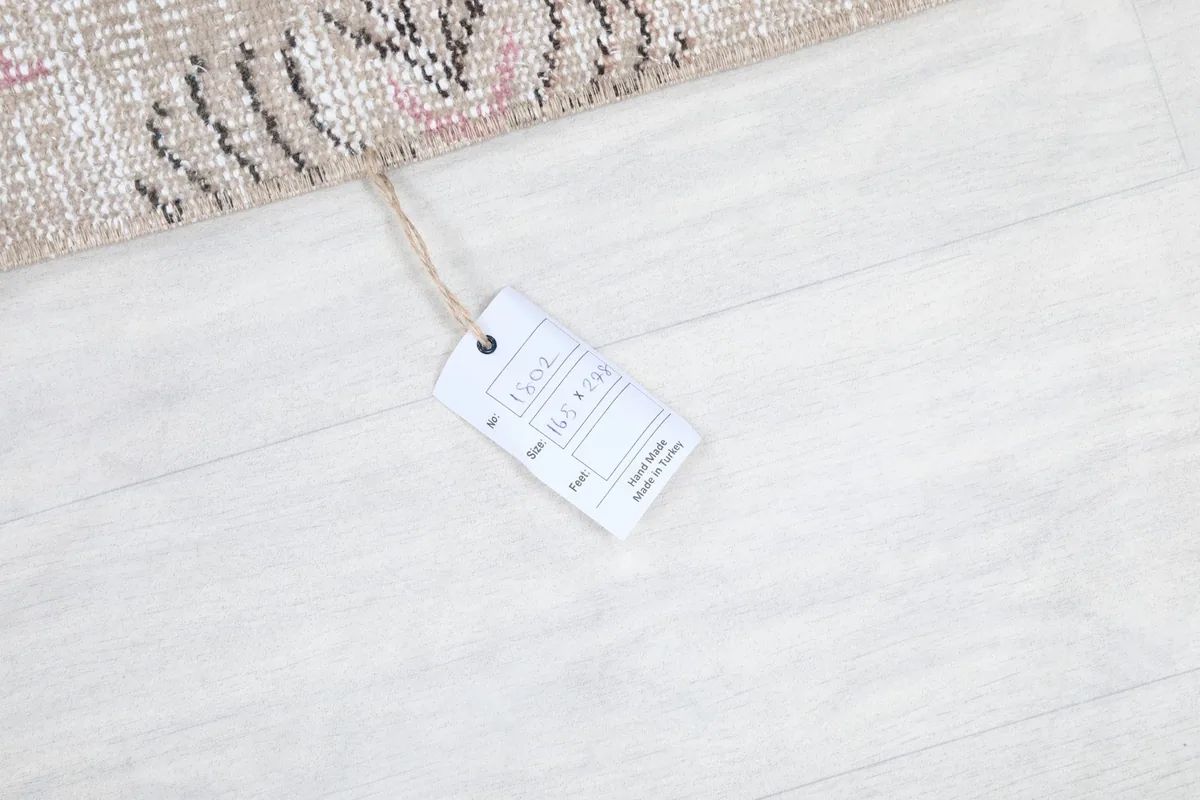 Close-up of the product tag, indicating the rug's size and origin