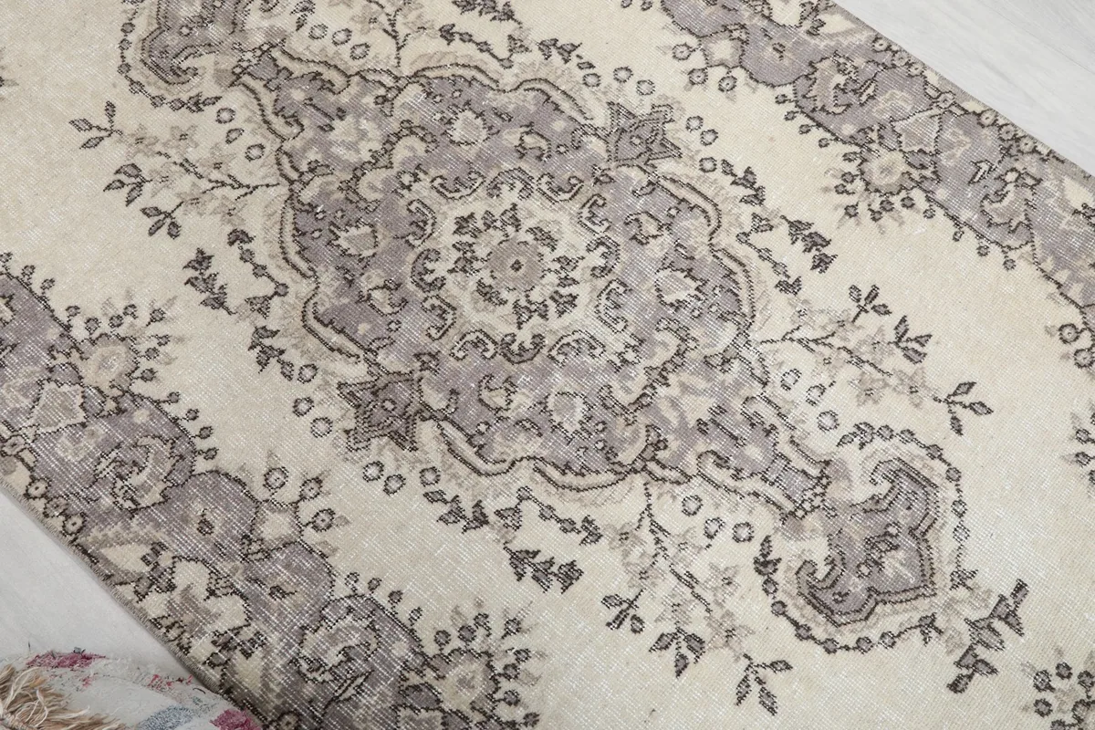 Overhead detail of the main gray medallion and surrounding floral motifs