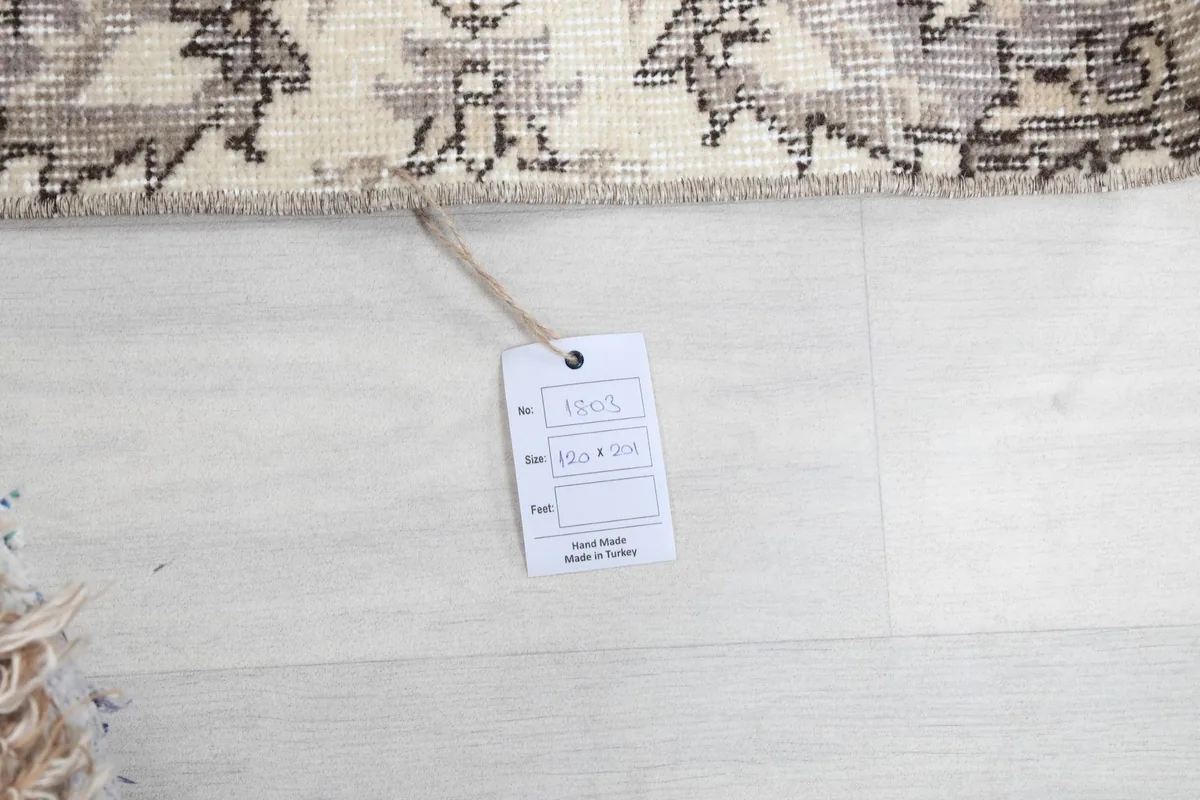 Product tag displaying the rug's material and origin, next to the rug's edge