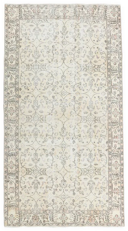 Top-down view of the 5'3" x 8'5" beige vintage Anatolian rug with floral and geometric patterns.