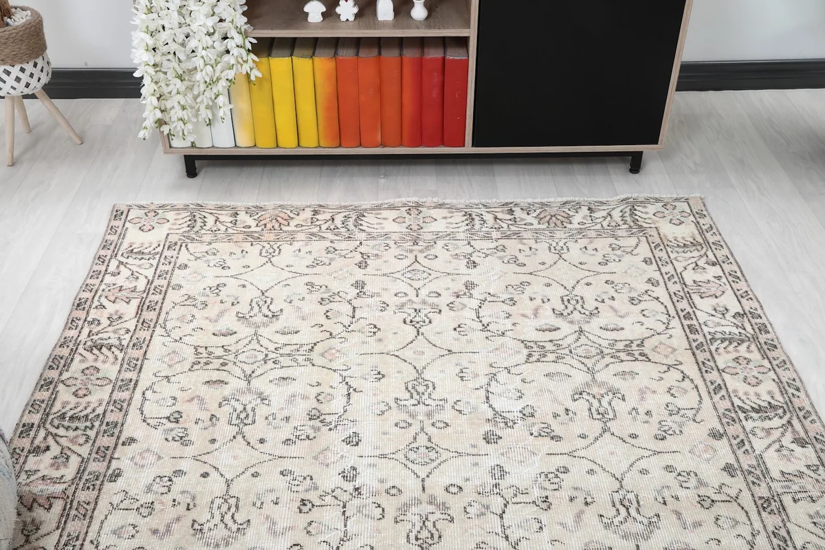 Full view of the beige rug in a living room, showcasing its overall design and muted colors.