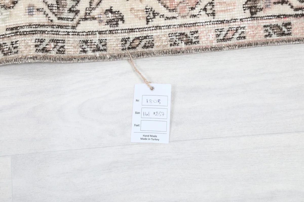 Product label with rug details and origin, displayed on the white floor next to the rug.
