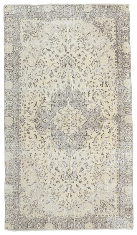 Full overhead view of the vintage cream and gray Anatolian rug on a white background