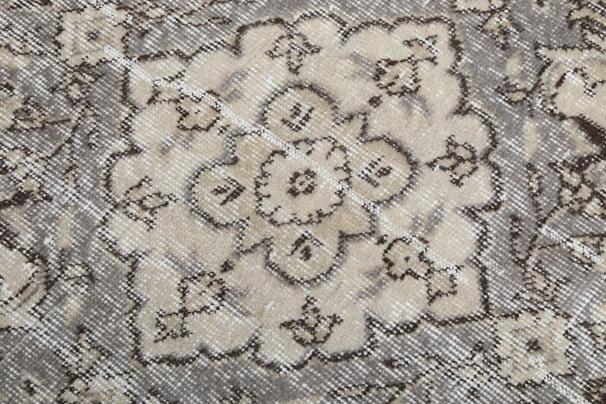 Very close detail of the central medallion's intricate floral design and low pile