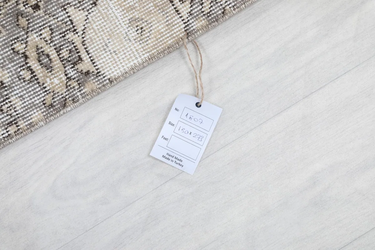 Product tag on the rug, displaying size and origin information