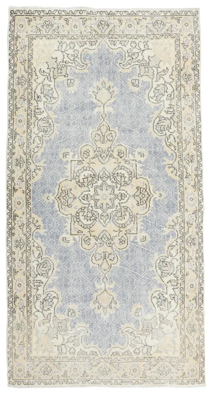 Full overhead view of the 4x7 vintage Anatolian rug with soft blue and ivory tones