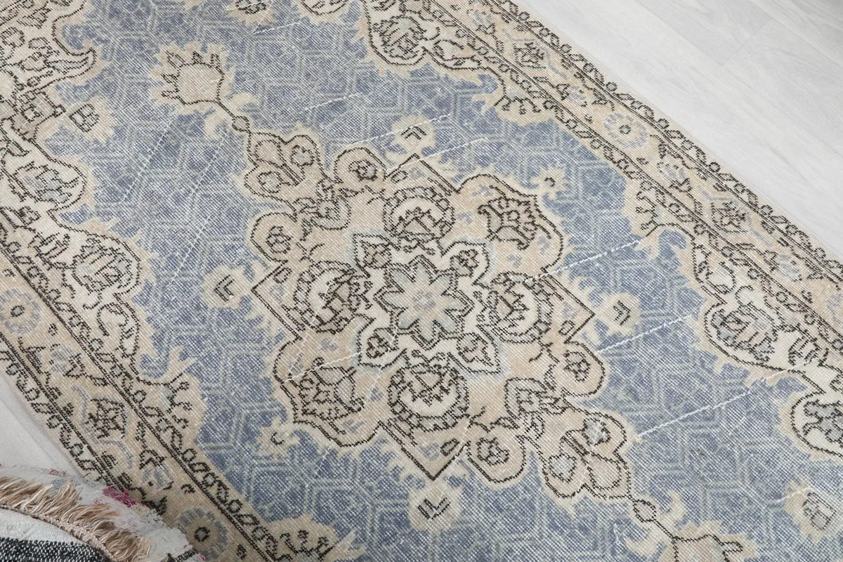 Angled view showcasing the central medallion and surrounding patterns on the blue field