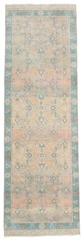 Full overhead view of the beige and rose floral Anatolian runner rug on a white background.