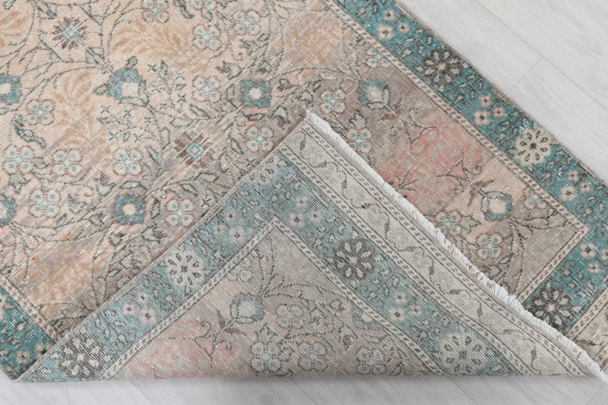 Underside of the rug, revealing the hand-knotted cotton foundation and wool pile.