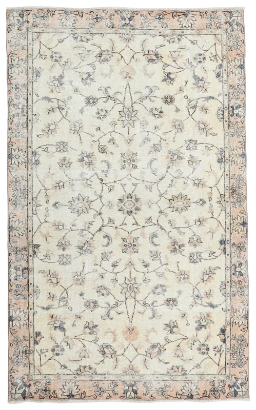 Overhead view of the 4'9" x 7'9" vintage Anatolian area rug with a cream field and floral motifs