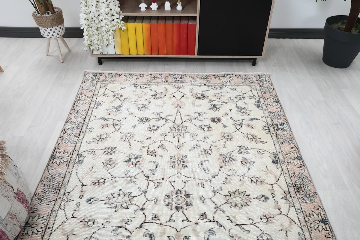 View of the vintage area rug from a different angle in the living room, showing its placement relative to furniture