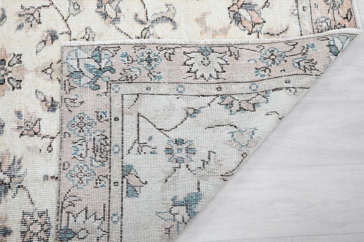 Close-up of the back of the rug, showing the tightly woven cotton foundation and details of the knots