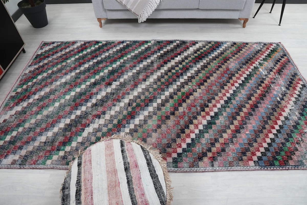 Overhead shot of the large area rug in a room, emphasizing its scale and design