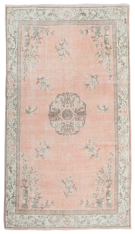 Full overhead view of the rose and ivory vintage Anatolian rug with floral and medallion design