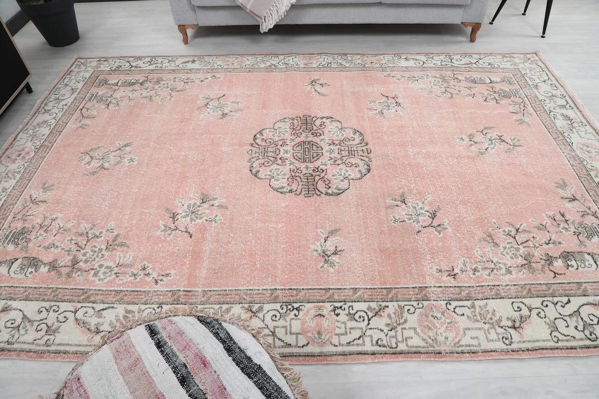 Full view of the rose vintage rug in the living room setting, seen from the front