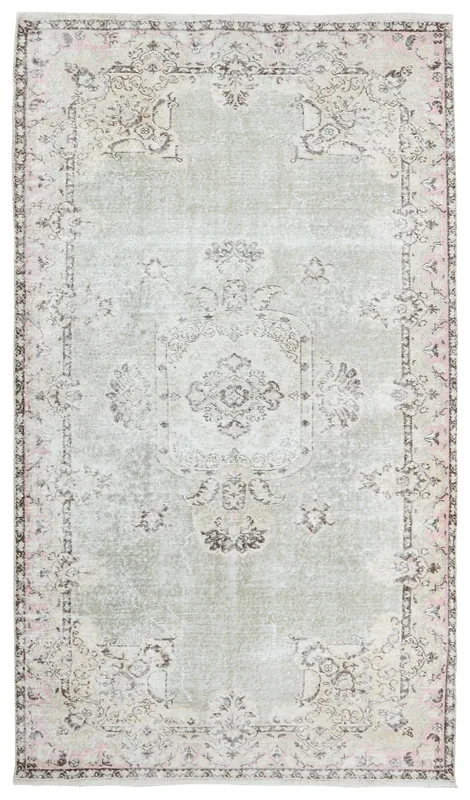 Full overhead view of a gray and rose vintage Anatolian rug with a central medallion
