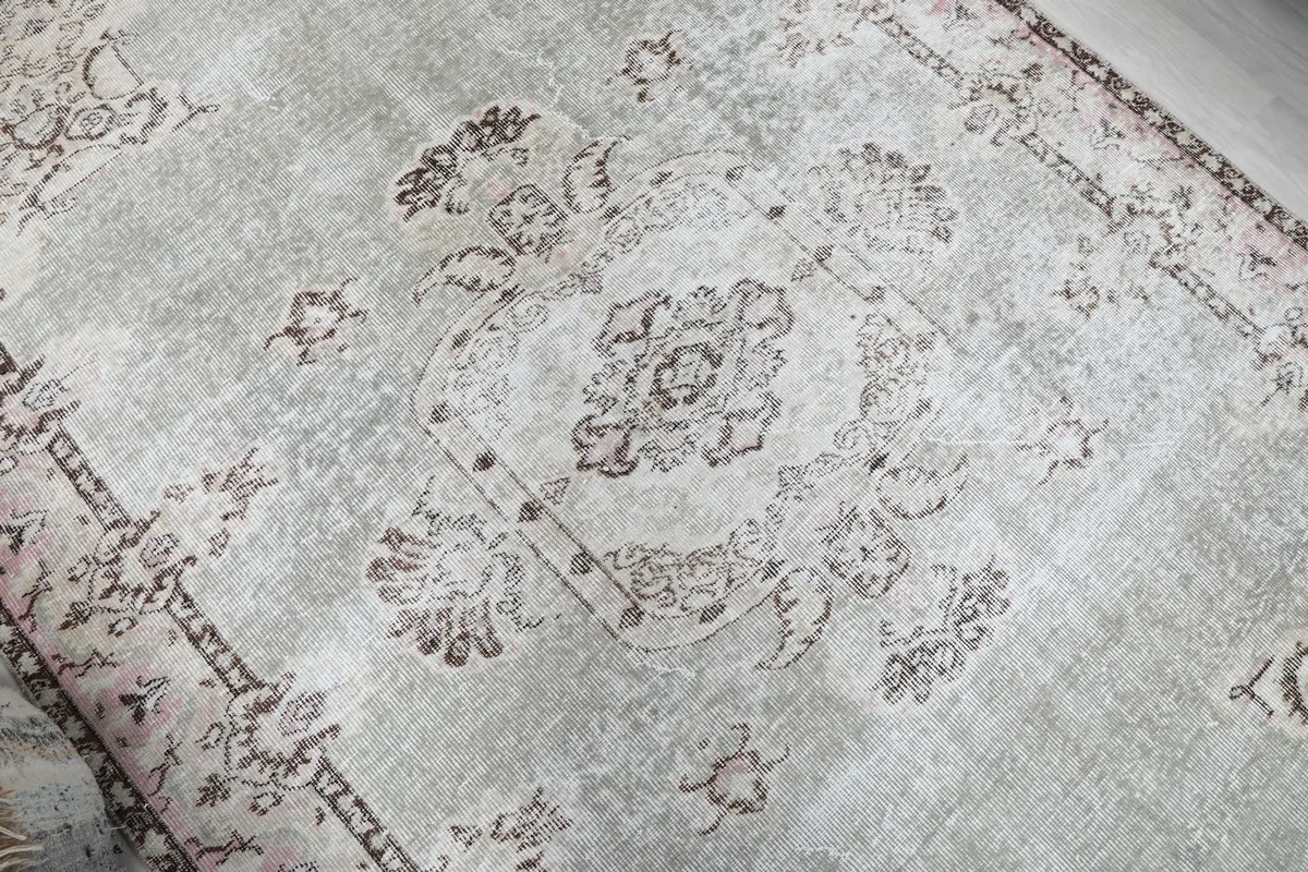 Close-up of the central medallion motif on the gray field of the rug