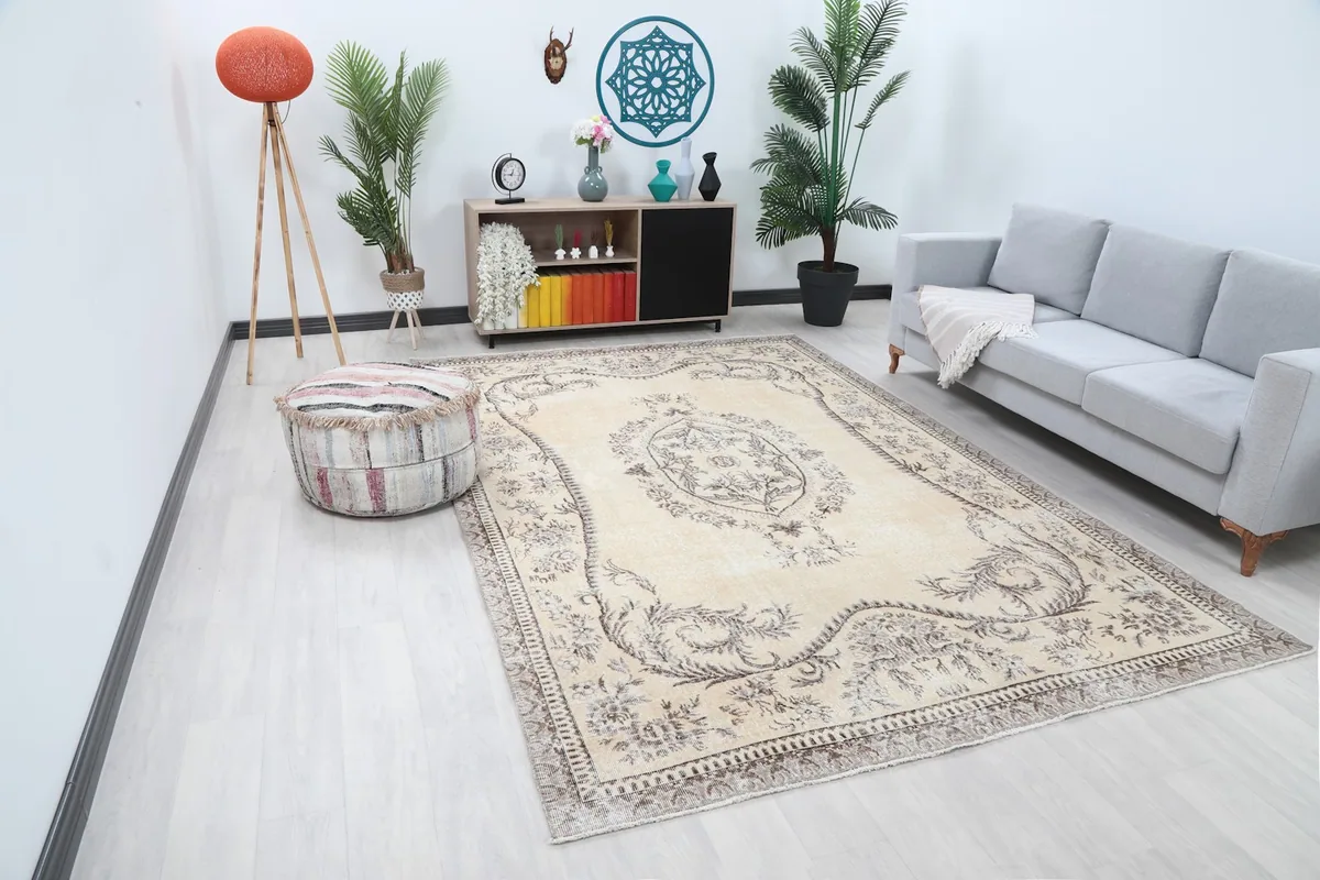 Angled view of the large beige and gray floral rug in a contemporary room