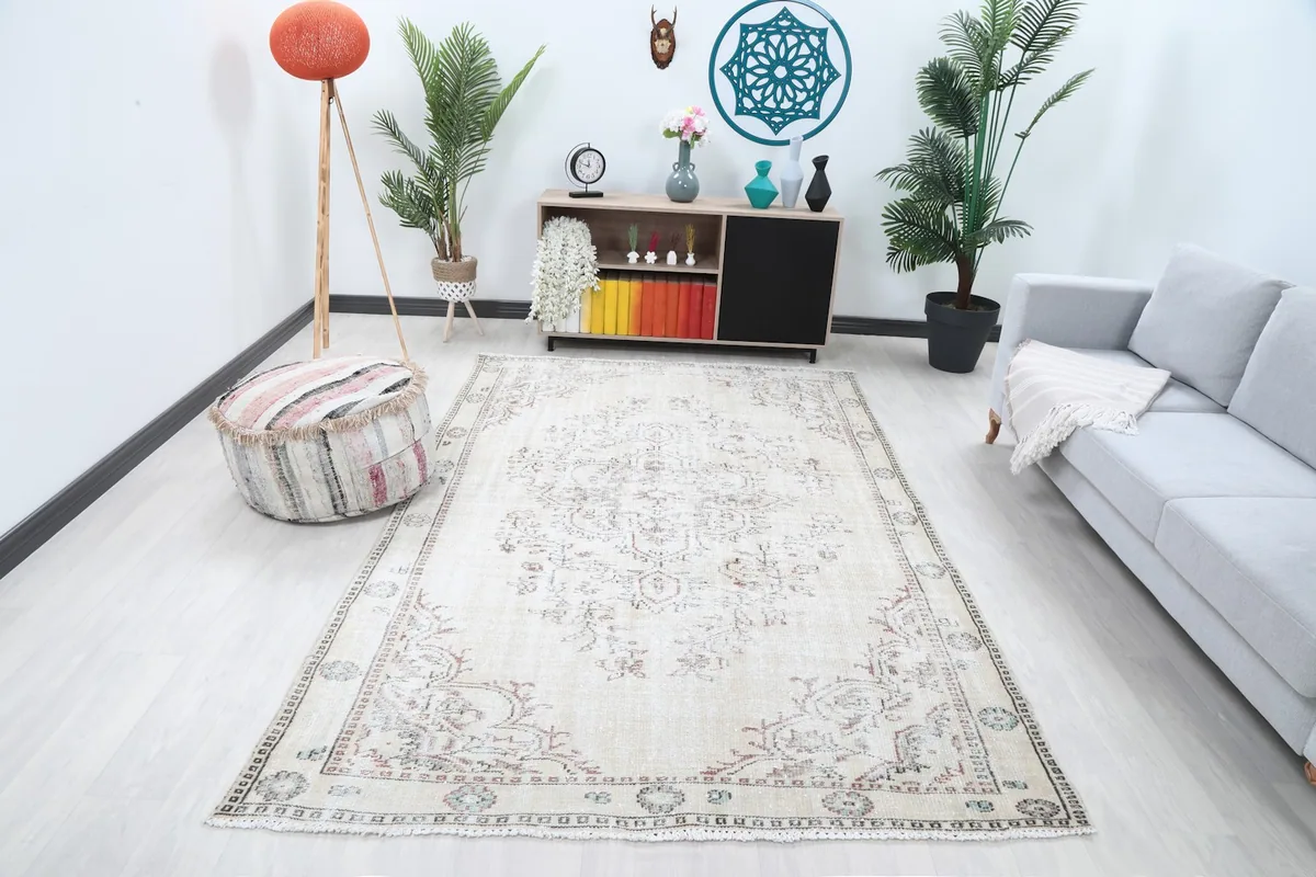Vintage Anatolian rug displayed in a modern living room setting with light furniture