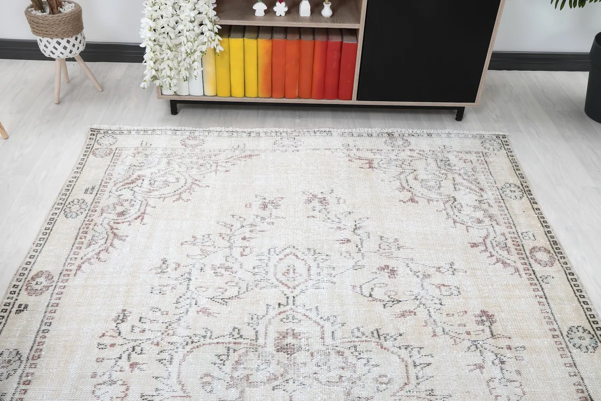 Overhead angle of the rug in a room, highlighting the full design and muted color palette