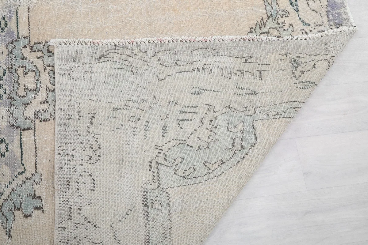 Close-up of the back of the rug and the tightly woven cotton foundation